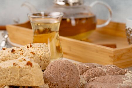 Turkish halva with tea in a glass cup close up
