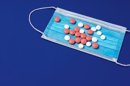 Vitamins and face protective mask. Coronavirus prevention conceptの写真素材