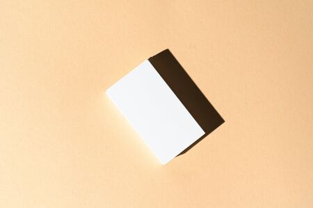 Stack of businesscards with copy space on beige backgroundの写真素材