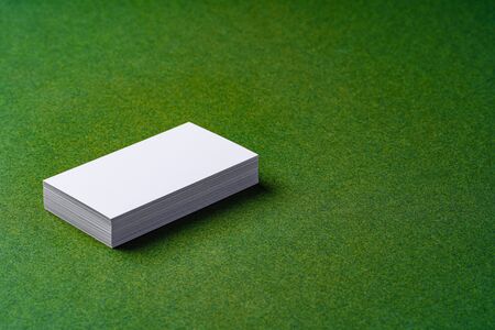 Stacks of white business cards on dark green backgroundの写真素材
