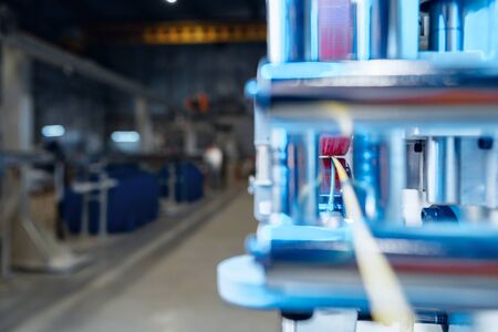 Inside a modern plant producing power electric cables and optical fibers. .Cable manufacturing machine part.の写真素材