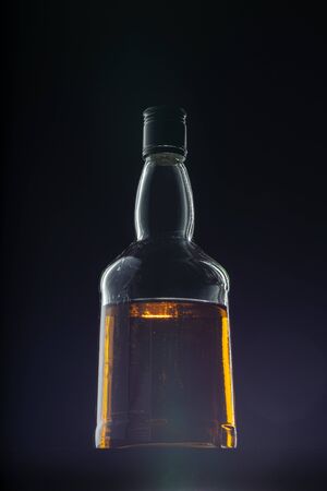 Bottle of whisky on black backgroundの写真素材