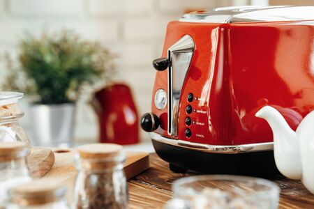 Ceramic teapot and toaster, kitchen table counter close upの写真素材
