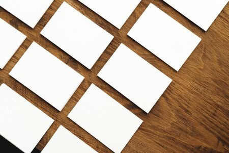 Blank businesscard stacks on rough wooden tableの写真素材