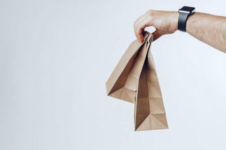 Courier hands giving packed food delivery close upの写真素材