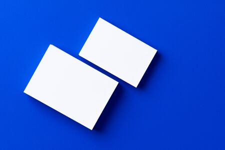Blank white businesscards on classic blue backgroundの写真素材