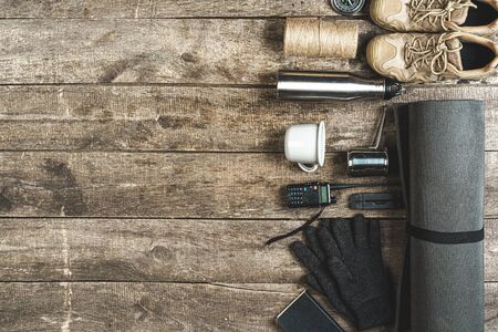 Top view of assorted hiking equipment tools on grunge wooden backgroundの写真素材