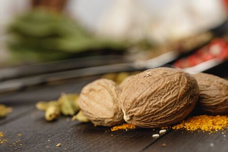 Nutmeg spice on dark wooden table close upの写真素材