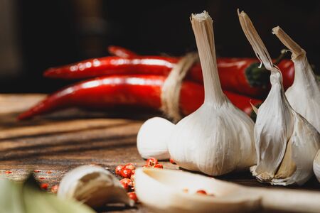 Garlic and chili pepper on dark wooden tableの写真素材