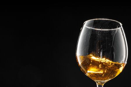 Glass of wine on black background, close upの写真素材