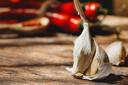 Garlic and chili pepper on dark wooden tableの写真素材