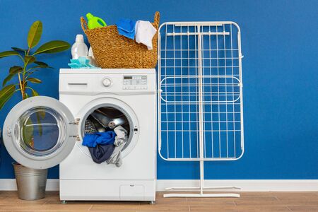 Laundry room interior with washing machine and clothes dryer near wallの写真素材