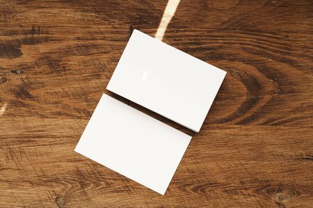 Stacks of businesscards with copy space on wooden background