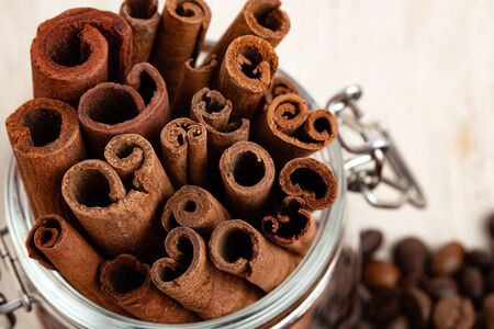 Glass jar with cinnamon sticks with roasted beans top view