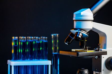 Microscope with lenses close up against dark background