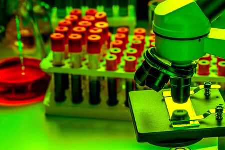 Close up photo of microscope with test tubes with blood samplesの写真素材