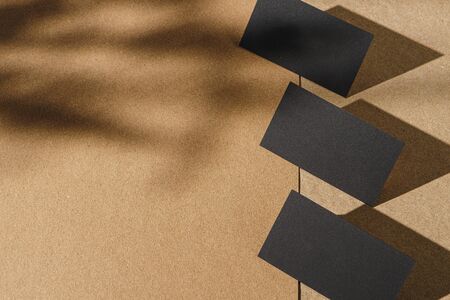 Black business cards on cork board table