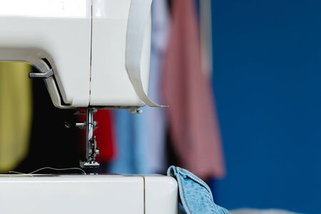 Electric sewing machine in a seamstress office close up