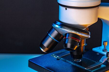 Microscope with lenses close up against dark backgroundの写真素材