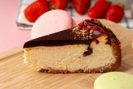 Piece of cheesecake with chocolate top and fresh berries