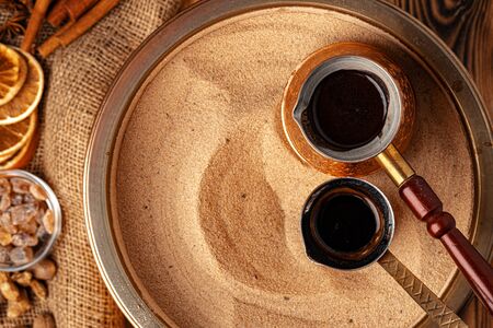 Process of preparation of coffee in turk in cezve on sandの写真素材