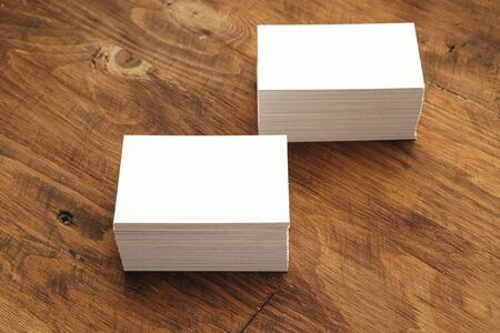 Blank businesscard stacks on rough wooden tableの写真素材