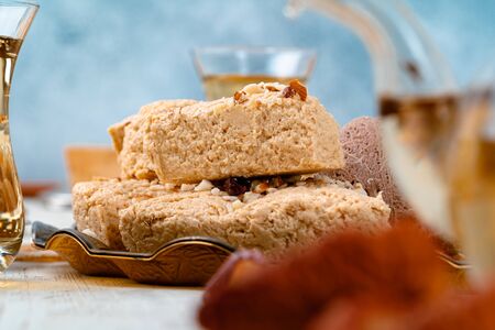 Turkish halva with tea in a glass cup close up