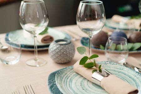 Luxury green table setting decorated with candles close up
