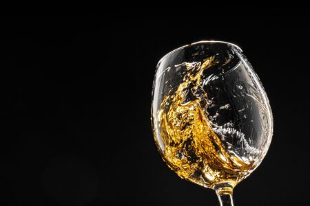 Glass of wine on black background, close upの写真素材