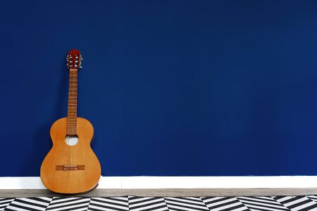 Guitar setup against classic blue wall in apartmentの写真素材