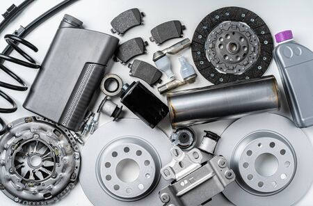 New metal auto parts on grey background