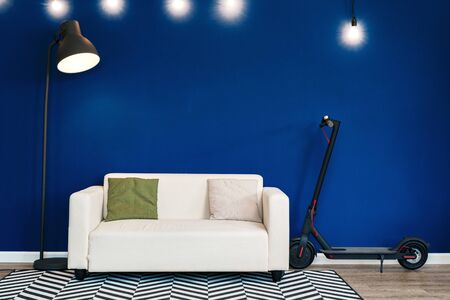 Modern living room interior with white sofa against blue wallの写真素材