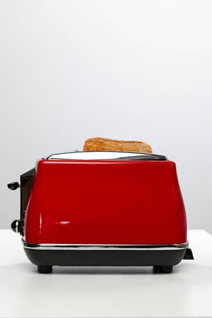 Couple of prepared toasts in a toaster, close upの写真素材