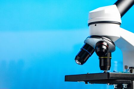 Lab microscope close up against blue backgroundの写真素材