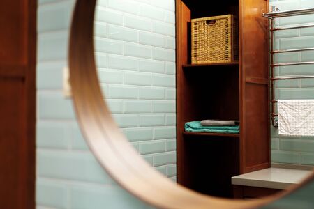Modern clean bathroom interior details with wooden furniture and mint tile wallsの写真素材