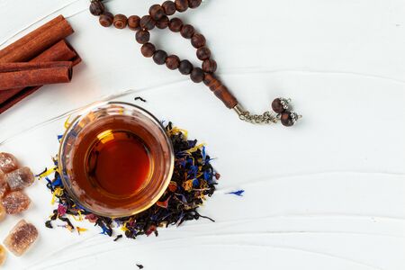 Cup of tea with cinnamon sticks on tableの写真素材