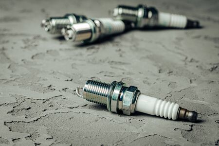 Car spark plugs on black grunge background close upの写真素材