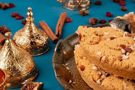 Turkish delight dessert on traditional tableware on dark blue table