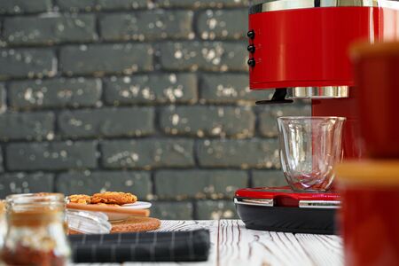 Red coffee machine with a glass on kitchen counterの写真素材