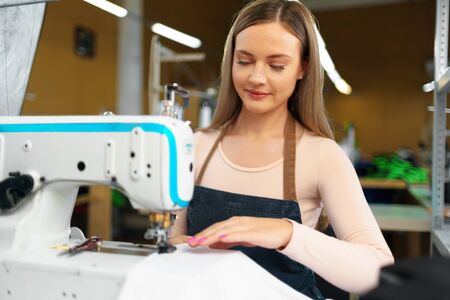 Portrait of seamstress working with sewing machine