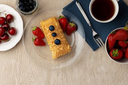 Piece of russian honey cake medovik served with fresh berries