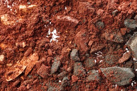 Background of smashed dark colored eyeshadows, top view