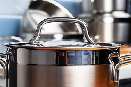 Set of aluminum cookware on kitchen counter close up