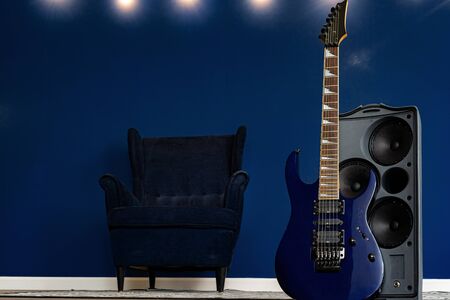 Guitar setup against classic blue wall in apartment. close up.の写真素材