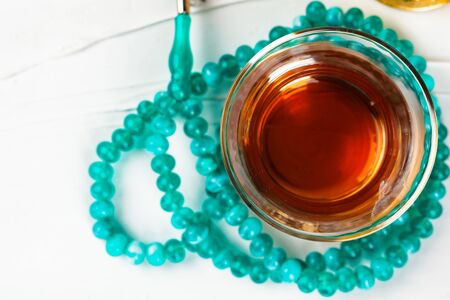 Cup of tea with islamic pray beadsの写真素材