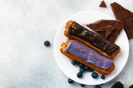 Close up photo of fresh french eclair cake with icing, copy space