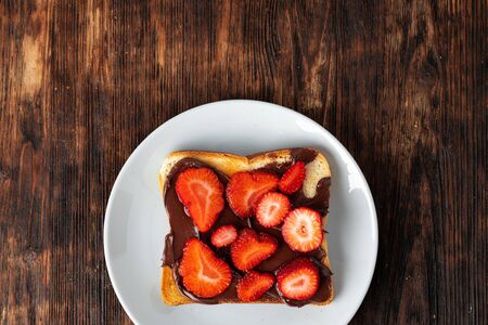 Sandwich toast with chocolate paste and cut strawberryの写真素材
