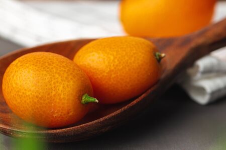 Heap of kumquat fruit on kitchen tableの写真素材