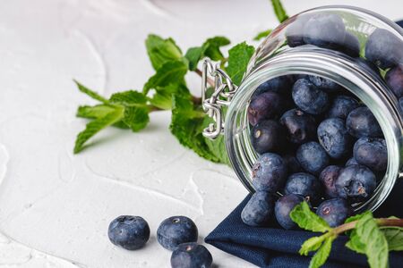 Pile of blueberries in a glass bowl close up
