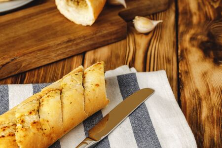 Sliced fresh baguette with garlic oil and herbsの写真素材